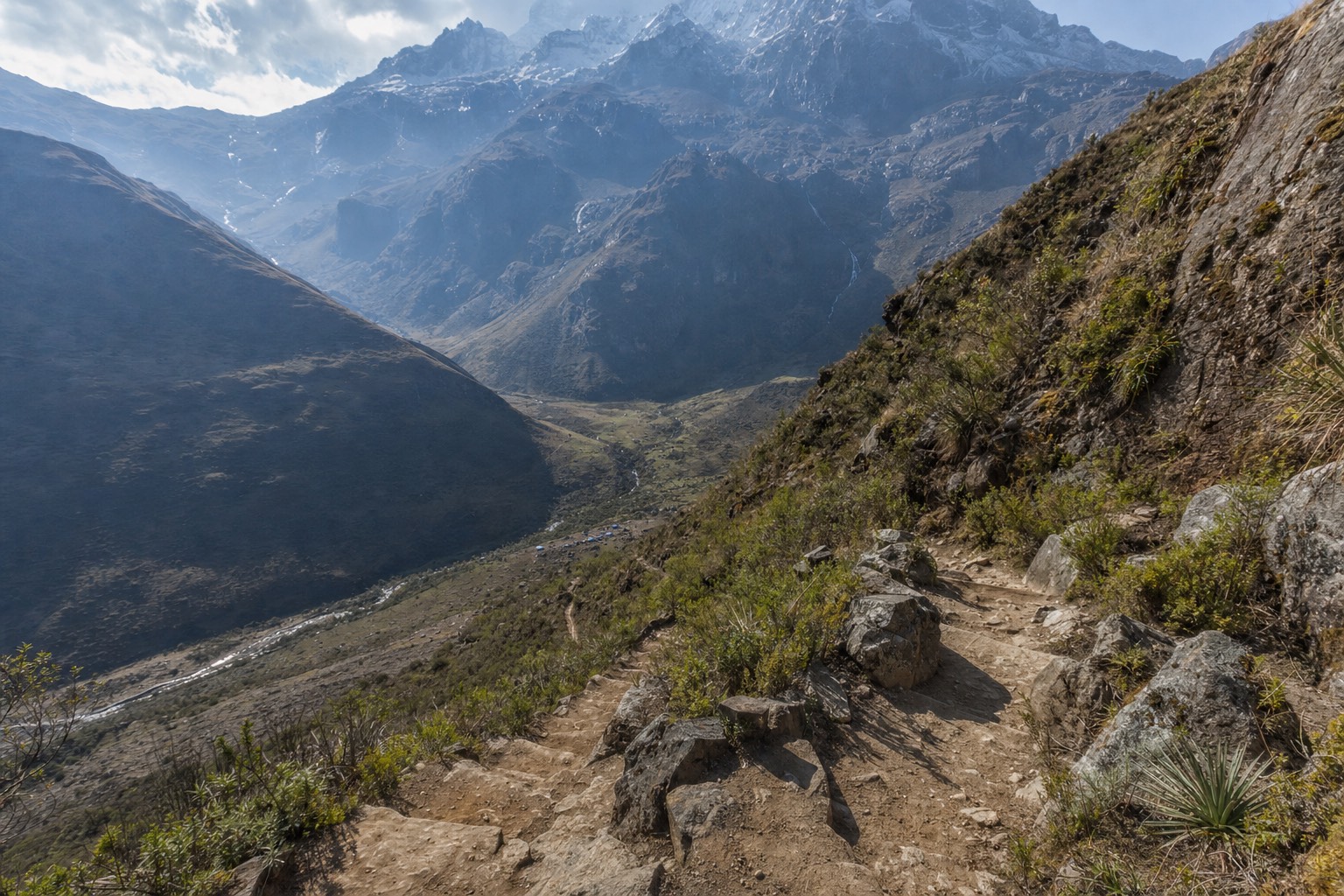 Hikers pausing to catch their breath on the steep rocky switchbacks above Soraypampa on the way to Humantay Lake